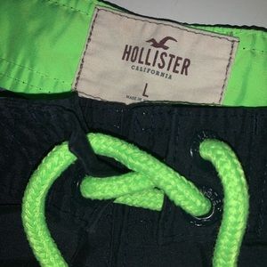 Navy swimming trunks with neon green draw strings